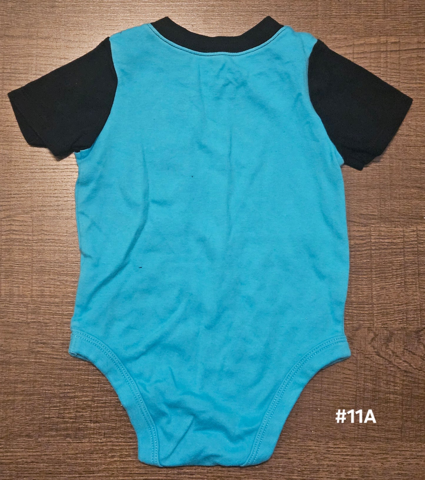 Blue Onesie With A Monster In The Pocket