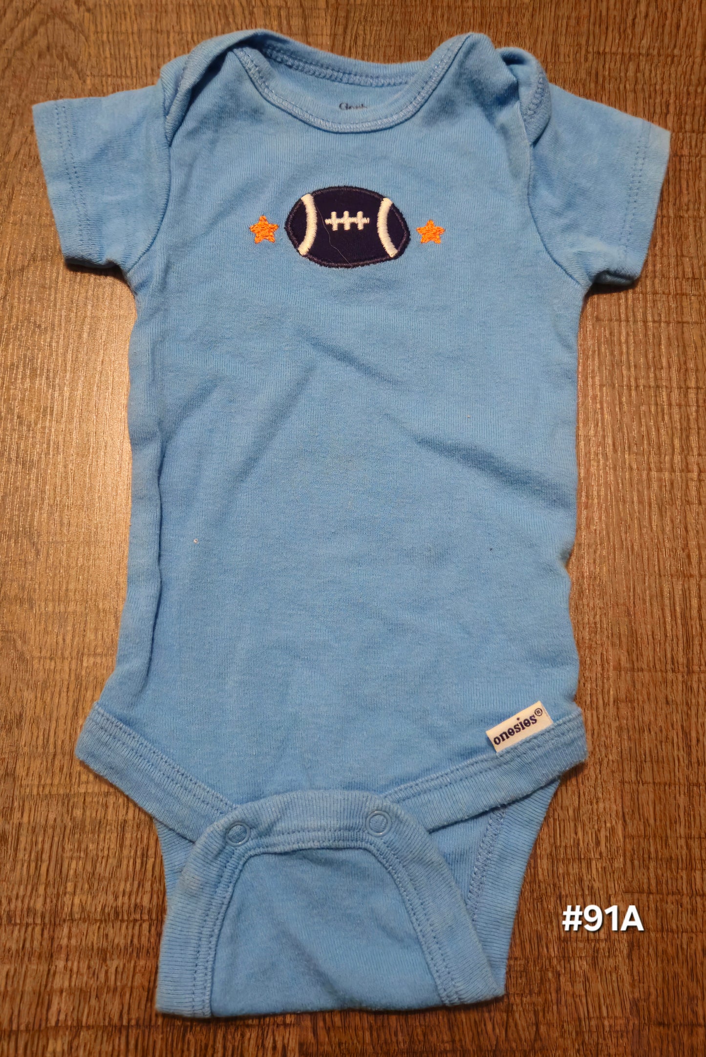 Blue Onesie With A Football On It
