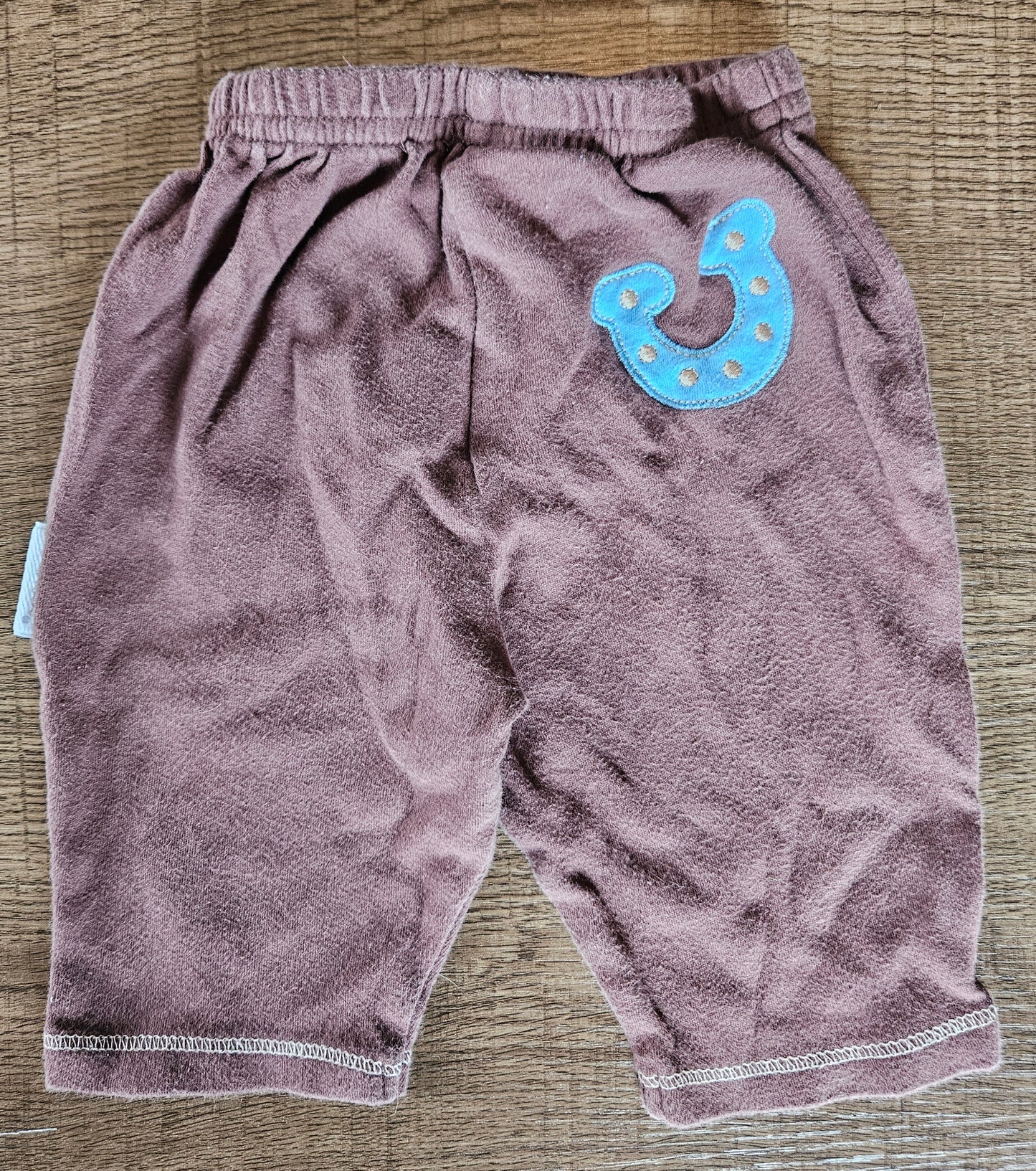 Brown Pants With Blue Shape On Them