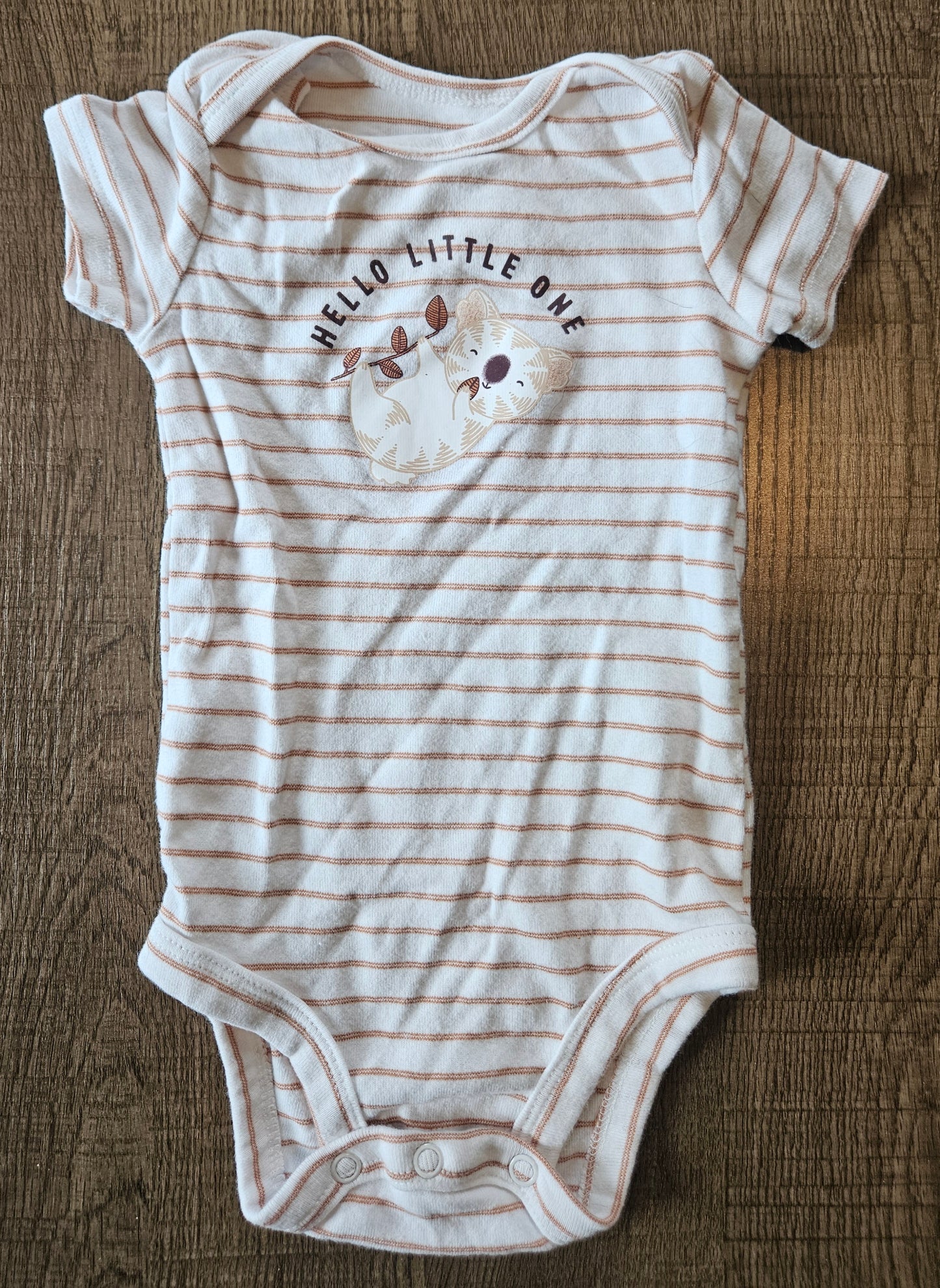 A White Onesie With Brown Stripes And A Koala That Says "Hello Little One"
