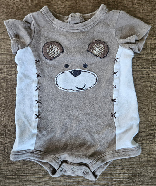 Brown Onesie With A Bear On The Chest.